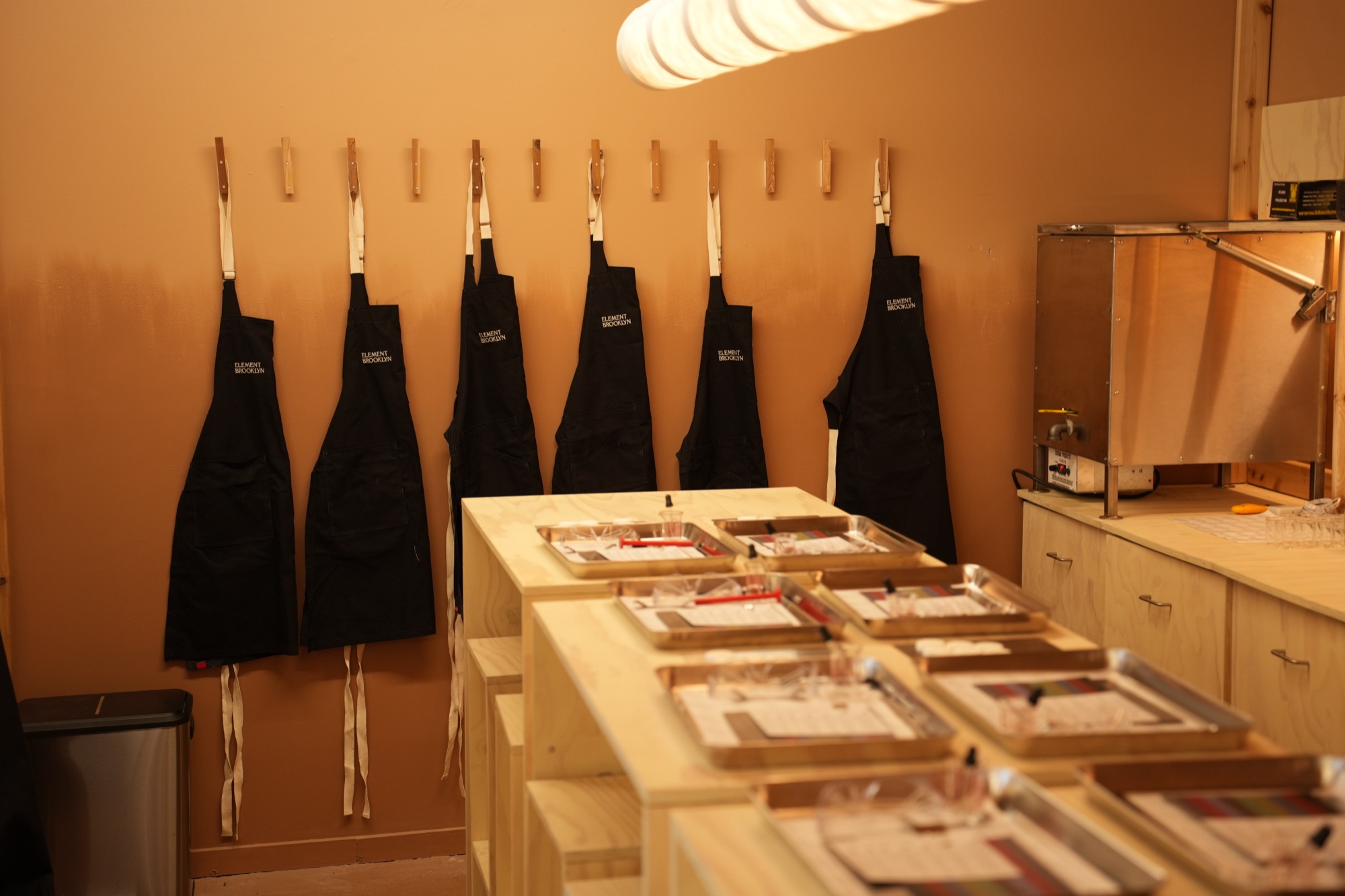 Aprons and set benches in the candle-making workshop