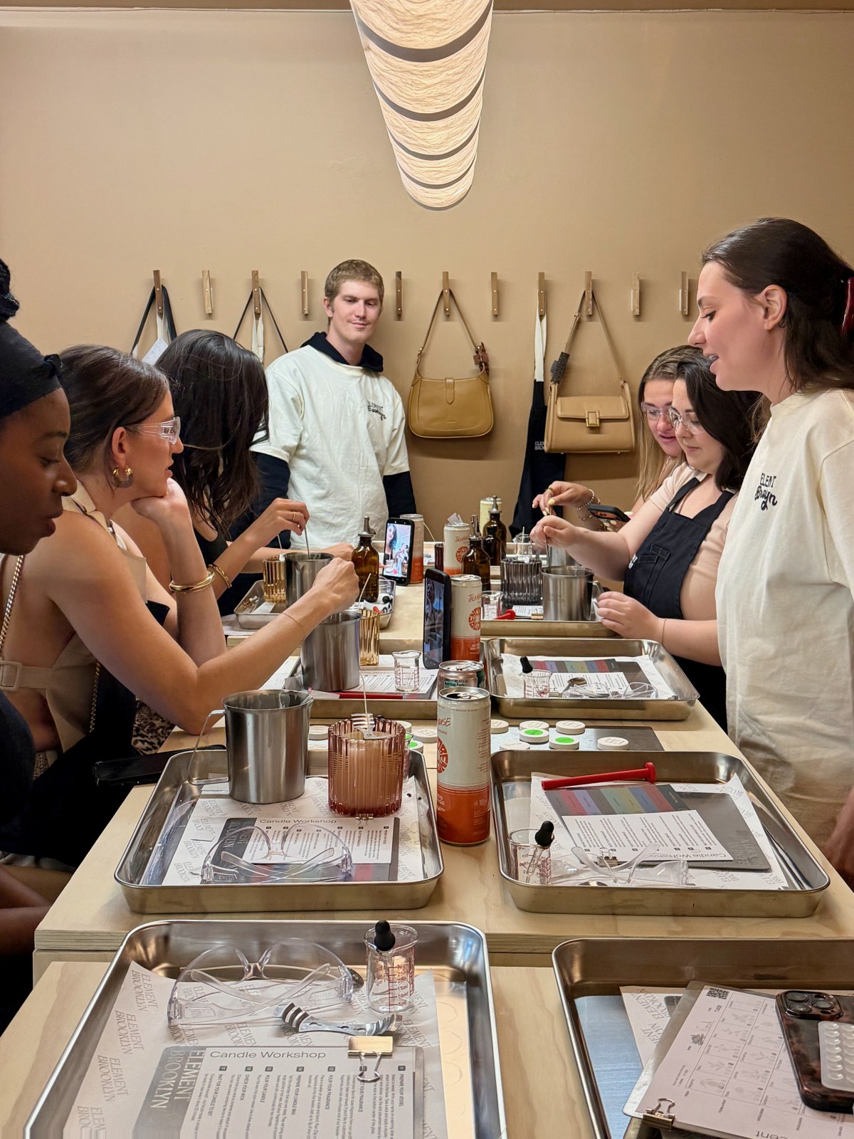 Guests at the workshop bench mixing fragrance with an Element Brooklyn host